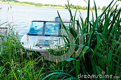 Motor boat, a boat in the reeds at the pier Stock Photo