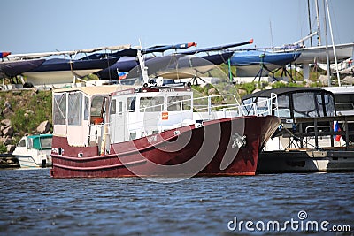 Motor boat with brown hull and white deckhouse on a sunny day Editorial Stock Photo