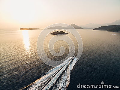 Motor boat sails to the Mamula fortress on the island. Kotor Bay Stock Photo