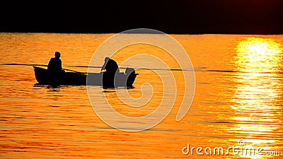 Motor boat with two passengers moving on a quiet autumn sea Stock Photo