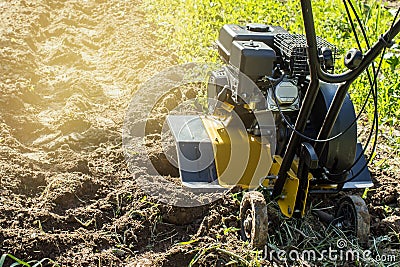 Motor cultivator fresh raw in garden soil Stock Photo