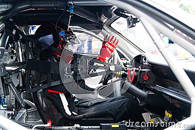 Motor sport Porsche GT driver in touring car cockpit with helmet and racing suit Editorial Stock Photo