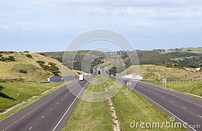 Motor Vehicles Travelling along Double Lane Highway Stock Photo