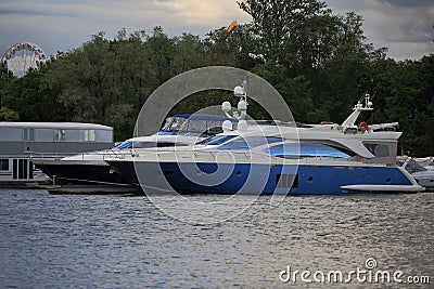 Motor yachts on a cloudy day are moored near the shore Editorial Stock Photo