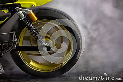 Motorbike burning tire rubber on road, Motorbike wheel drifting and white smoking on track, Motorcycle wheel on racing track with Stock Photo