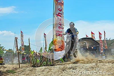 A motorbike cross racer is practicing on a dusty track Editorial Stock Photo