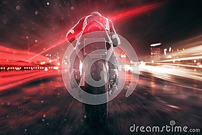 Motorbike drives through night city Stock Photo