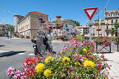 Motorbike drives through the town of Sisteron Editorial Stock Photo