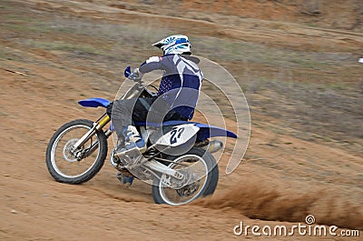Motorbike racer accelerates from turning Stock Photo