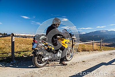 Motorbike traveler in mountains Stock Photo