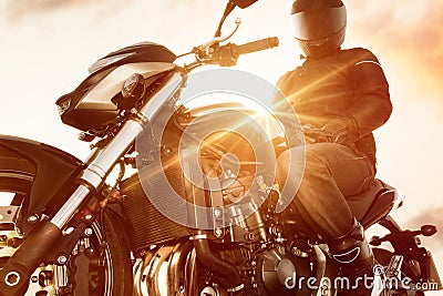 Motorbiker on his Motorbike Stock Photo