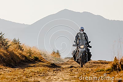 Motorbiker travelling in autumn mountains Stock Photo