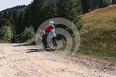 Motorbiker travelling, summer day, motorcycle off road, the driver with adventure, touring motorbike with side bags, extreme Stock Photo