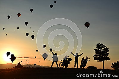 Motorbikers waving at hot air balloons Stock Photo