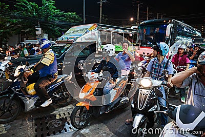 Motorbikes at a crossroads at night in Thailand Editorial Stock Photo