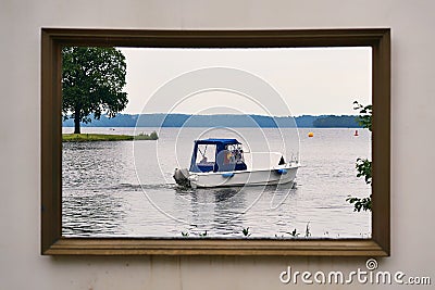 Motorboat on the Schwerin lake in the picture frame. Castle garden in Mecklenburg-Vorpommern Stock Photo