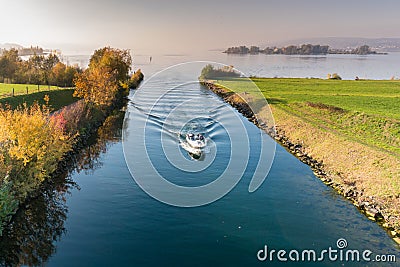 Motorboat with tourist people passes from the lower to the upper Lake Zurich through the locks and passage on the Seedamm near Rap Editorial Stock Photo