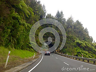 Motorcar driving on road tunnel carved out of rock mountain Editorial Stock Photo