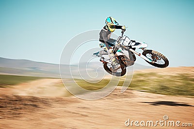 Motorcross, air jump and offroad sports with motion blur, speed challenge or desert. Driver, cycling and stunt on dirt Stock Photo