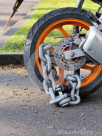 Motorcycle anti-theft chain with padlock security lock on rear w Stock Photo