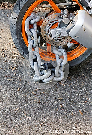 Motorcycle anti-theft chain with padlock security lock on rear w Stock Photo