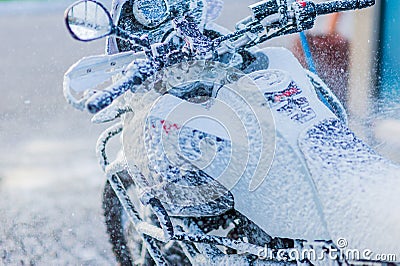 Motorcycle Car Wash Motorcycle Big Bike cleaning with foam injection Stock Photo