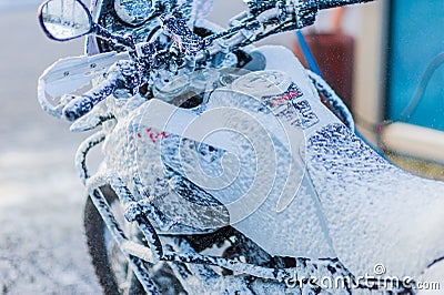 Motorcycle Car Wash Motorcycle Big Bike cleaning with foam injection Stock Photo