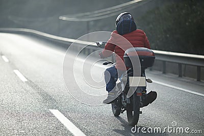 Motorcycle Courier On The Highway Stock Photo