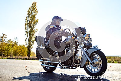 Motorcycle Driver Riding Custom Chopper Bike on Autumn highway. Adventure Concept. Editorial Stock Photo