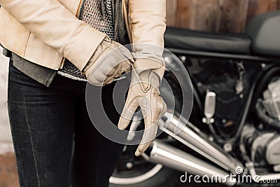 Motorcycle kaferacers. Girl dress leather gloves. Beige leather gloves. Gloves for motorcycle riding. Stock Photo