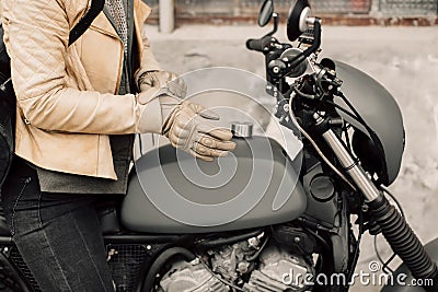 Motorcycle kaferacers. Girl dress leather gloves. Beige leather gloves. Gloves for motorcycle riding. Stock Photo