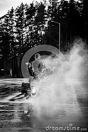 Motorcycle leaves in a smoke. Stock Photo