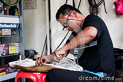 Motorcycle mechanic working in his shop Editorial Stock Photo