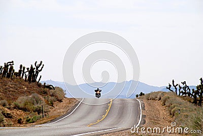 Motorcycle riding in desert Stock Photo