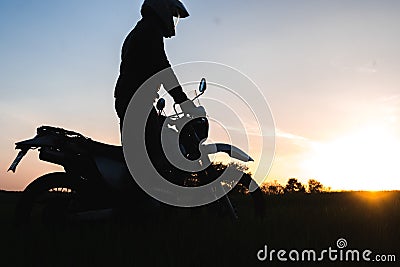 Motorcycle silhoette enduro off road adventure sunset sunrise Stock Photo