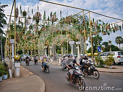 Motorcycle traffic crossing the bridge over the Siem Reap River near the Royal Residence in central Siem Reap, Cambodia Editorial Stock Photo
