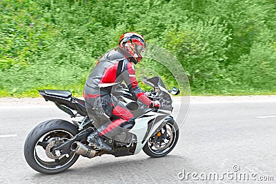 Motorcyclist biker fast riding Stock Photo