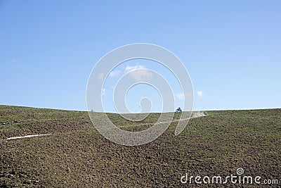 Motorcyclist likes to run on the ridges of the hills Stock Photo