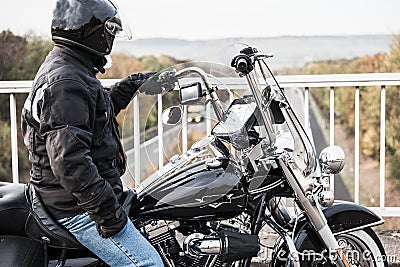 Motorcyclist looks at the highway Stock Photo