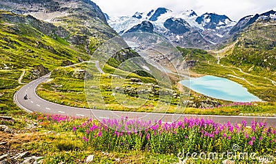 Motorcyclist on mountain pass road in the Alps Stock Photo