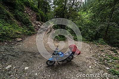 Motorcyclist on a mountainous road, cold overcast weather. Extreme sport, Sainj Valley, Himachal Pradesh, India Editorial Stock Photo
