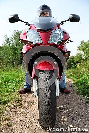 Motorcyclist standing on country road, closeup Stock Photo