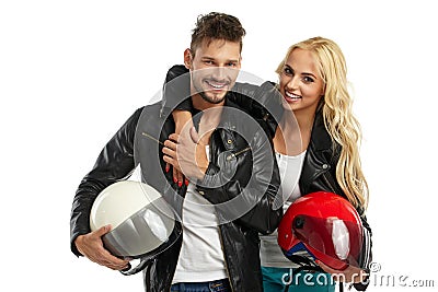 Motorcyclists couple with helmets in hand Stock Photo