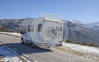 Motorhome climbing slowly by mountains pass Stock Photo