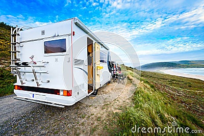 Motorhome RV and campervan are parked on a beach Stock Photo