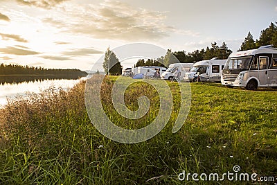 Motorhomes parked at a river in Sweden. Editorial Stock Photo