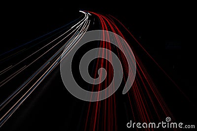 Motorway at night with fast moving cars Stock Photo