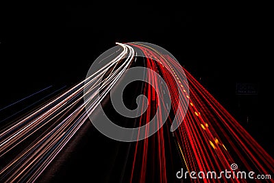 Motorway at night with fast moving cars Stock Photo