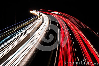 Motorway at night with fast moving cars Stock Photo