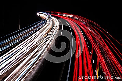 Motorway at night with fast moving cars Stock Photo